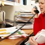 Woman in office yelling on phone